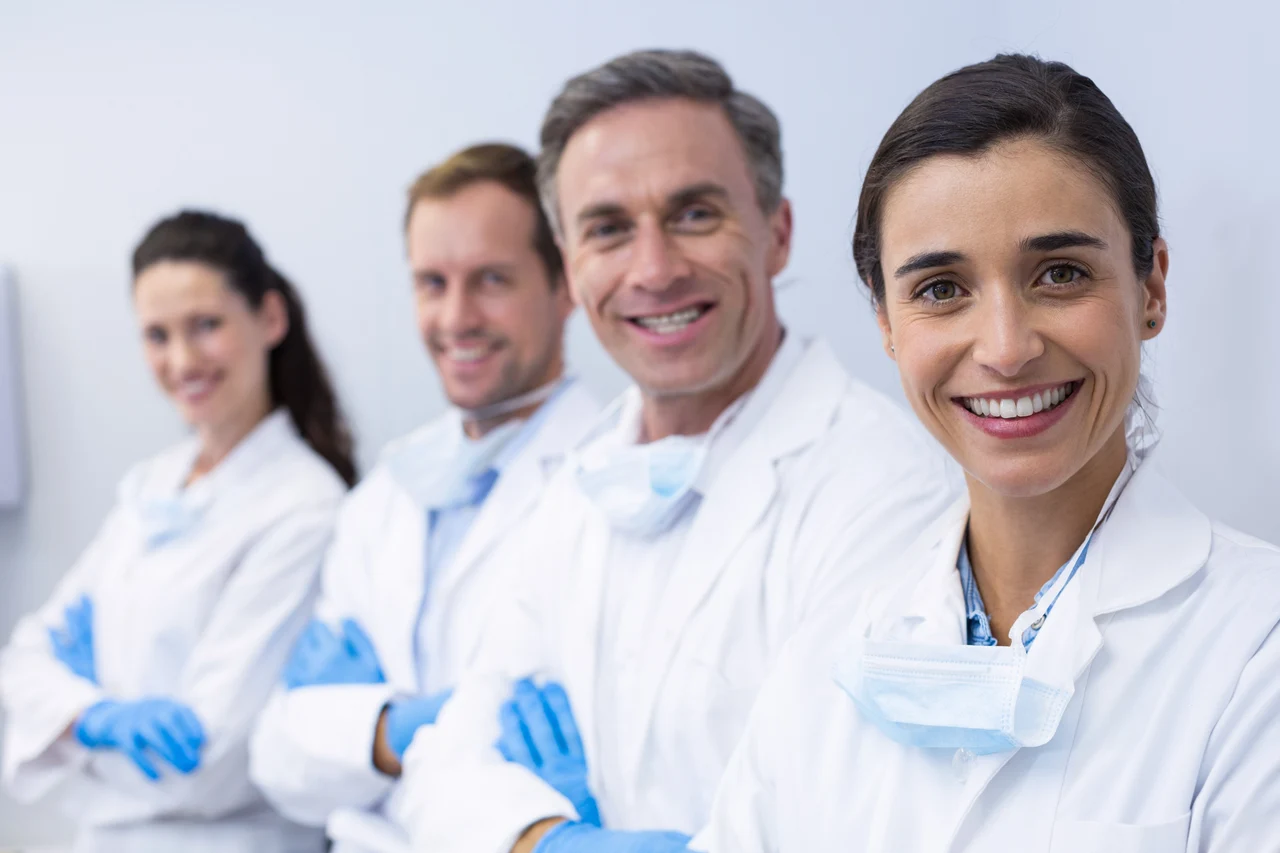 A team of dentists standing together in a dental practice
