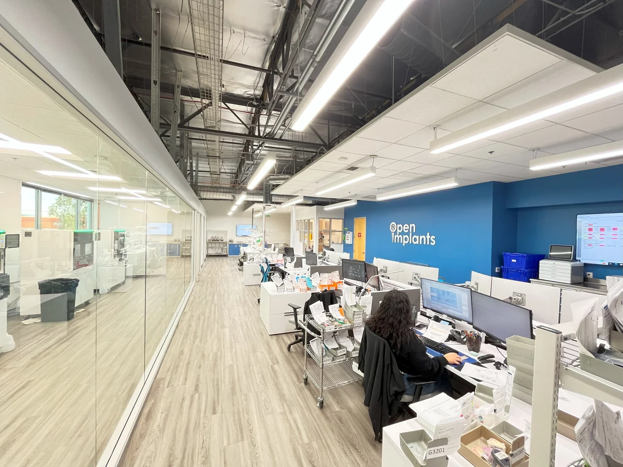 Open Implants office and workstations with its sign on a blue wall