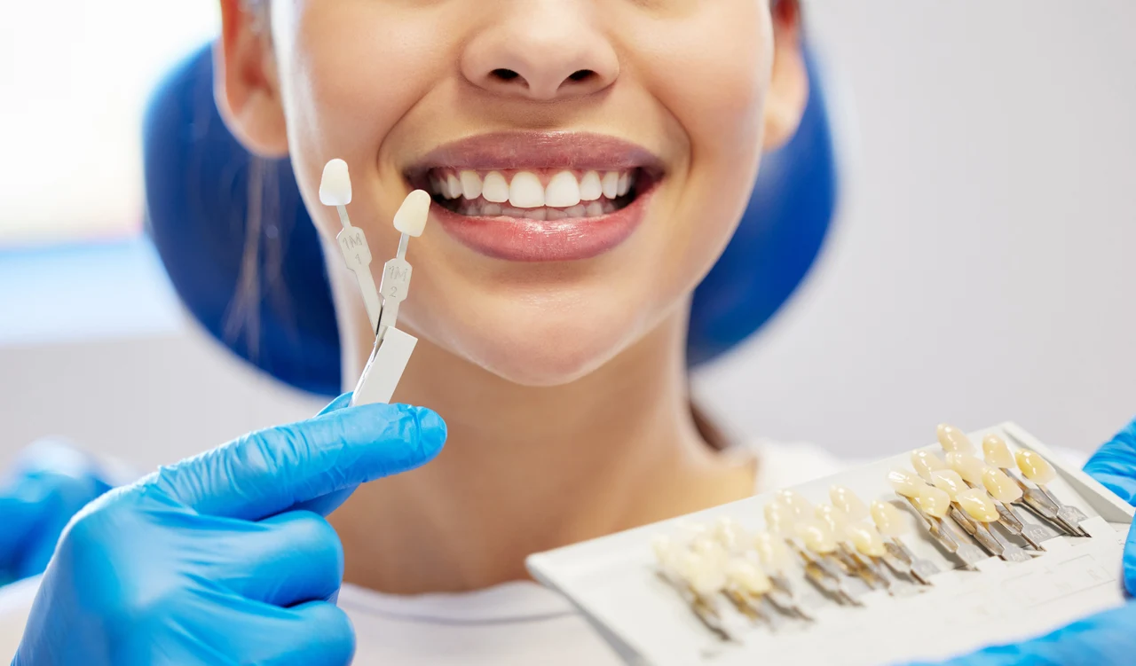 Dental professional discussing tooth shade and veneers with a patient